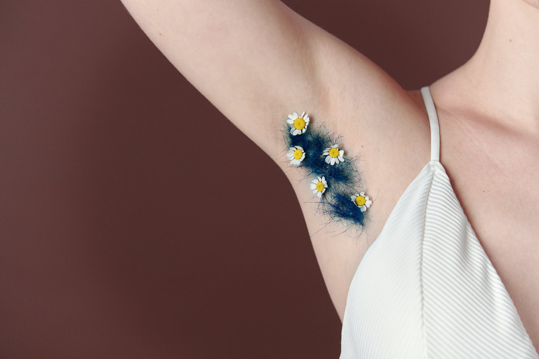 a woman axillary hair with daisies